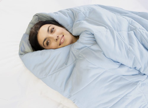 Woman happily wrapped in a blanket