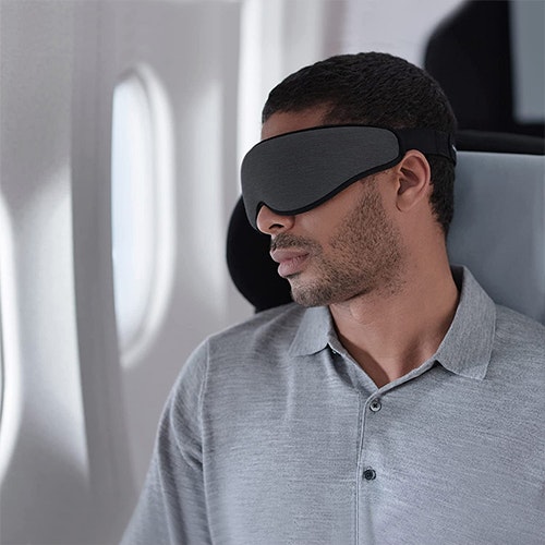 Man using the neck wrap while working on his laptop