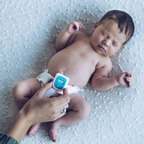 Snuza Pico Smart Wearable Baby Monitor attached to the nappy of the baby