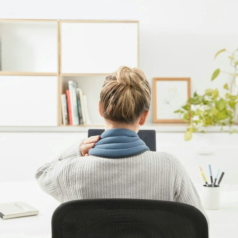 OstrichPillow Heated Neck Wrap Using at work