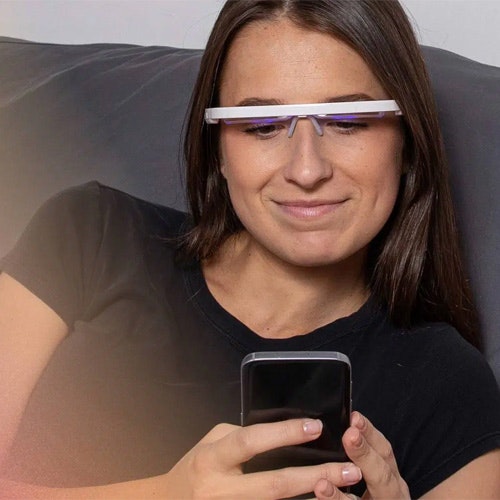 Woman using the AyoPro Light Therapy Glasses